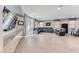 Bright living room features tile floors, a large sectional couch, and plenty of natural light at 689 Silver Pearl St, Henderson, NV 89002