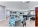 Open-concept living and dining area featuring wood-look floors and contemporary decor at 689 Silver Pearl St, Henderson, NV 89002