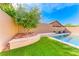 Backyard pool area featuring lush landscaping and a stylish, modern design at 689 Silver Pearl St, Henderson, NV 89002