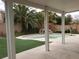Inviting backyard with covered patio, artificial turf, in-ground pool and rock waterfall feature at 7073 Seabirds Pl, North Las Vegas, NV 89084