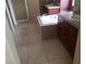 Bright bathroom features a soaking tub and a vanity with a solid surface countertop at 7073 Seabirds Pl, North Las Vegas, NV 89084