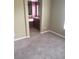Bedroom with plush carpeting and a view into the attached bathroom featuring red walls and tiled flooring at 7073 Seabirds Pl, North Las Vegas, NV 89084