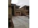 Two-story tan home with a concrete driveway, shutters, and an attached garage at 7073 Seabirds Pl, North Las Vegas, NV 89084