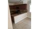 A partial view of kitchen with brown cabinets, granite countertops, and tiled floor at 7073 Seabirds Pl, North Las Vegas, NV 89084