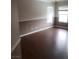 Spacious living room features hardwood floors, windows, and neutral color palette at 7073 Seabirds Pl, North Las Vegas, NV 89084