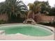 Relaxing in-ground pool with lush landscaping and rock waterfall feature at 7073 Seabirds Pl, North Las Vegas, NV 89084