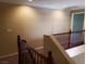 Upstairs landing with wood railing, neutral walls, and carpeted staircase to enhance the space at 7073 Seabirds Pl, North Las Vegas, NV 89084
