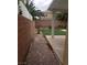 Paver walkway leads to backyard featuring artificial turf and an in-ground pool at 7073 Seabirds Pl, North Las Vegas, NV 89084
