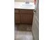 Bathroom featuring a wood vanity with a white sink and tile flooring at 7342 Tanglewood Park St, Las Vegas, NV 89166
