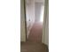 Hallway featuring carpet flooring with view into another room through a doorway at 7342 Tanglewood Park St, Las Vegas, NV 89166