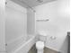 Bathroom featuring a white tile shower and toilet, along with neutral colored walls at 7452 Sunray Point St, North Las Vegas, NV 89084