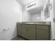 Contemporary bathroom vanity with a large mirror, sleek fixtures, and stylish cabinetry at 7452 Sunray Point St, North Las Vegas, NV 89084