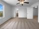 Bright bedroom with a ceiling fan and en-suite bathroom entrance featuring neutral carpeting at 7452 Sunray Point St, North Las Vegas, NV 89084