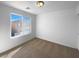Bright bedroom with a large window and neutral carpeting provides a cozy space at 7452 Sunray Point St, North Las Vegas, NV 89084