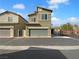 Two story tan home with a two car garage and desert landscaping at 7452 Sunray Point St, North Las Vegas, NV 89084