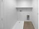 Functional laundry room with ample shelving and a convenient utility sink at 7452 Sunray Point St, North Las Vegas, NV 89084