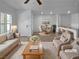 Staged open-concept living area with modern decor, seamlessly blending into a dining area at 7452 Sunray Point St, North Las Vegas, NV 89084