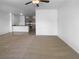 Open-concept living room with neutral walls and carpeted flooring that flows into the kitchen at 7452 Sunray Point St, North Las Vegas, NV 89084