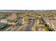 Scenic aerial view of the community entrance with desert landscaping, covered entry, and mountain views at 746 Purple Knoll Walk, Henderson, NV 89011