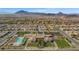 Aerial view showcasing community clubhouse, lush lawns, large swimming pool, and desert mountain backdrop at 746 Purple Knoll Walk, Henderson, NV 89011