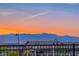 Picturesque community view featuring a mountain range and desert homes under a vibrant sunset sky at 746 Purple Knoll Walk, Henderson, NV 89011