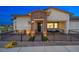 Inviting home exterior featuring a stone facade, black metal gate, and a welcoming covered porch at 746 Purple Knoll Walk, Henderson, NV 89011