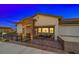 Well-maintained home exterior with stone accents, a cozy front porch and wrought iron gate at 746 Purple Knoll Walk, Henderson, NV 89011