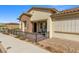 Beautifully landscaped single-story home with stone accents, a tiled roof, and a charming gated porch at 746 Purple Knoll Walk, Henderson, NV 89011