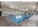 Bright indoor swimming pool with seating areas, natural light and high ceilings at 746 Purple Knoll Walk, Henderson, NV 89011