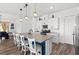 Bright kitchen features a center island with seating, white cabinets, and modern appliances at 746 Purple Knoll Walk, Henderson, NV 89011