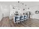 Spacious kitchen featuring white cabinets, a blue island with seating, and stainless steel appliances at 746 Purple Knoll Walk, Henderson, NV 89011