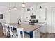 Kitchen island with seating, granite countertops, and a view into dining and living areas at 746 Purple Knoll Walk, Henderson, NV 89011