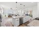 Open concept kitchen with a large island, stainless steel appliances, and wood flooring at 746 Purple Knoll Walk, Henderson, NV 89011