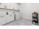 Bright laundry room featuring a washer, dryer, and built in cabinets at 746 Purple Knoll Walk, Henderson, NV 89011