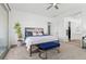 Spacious main bedroom with a sitting bench, accent wall, and natural light at 746 Purple Knoll Walk, Henderson, NV 89011