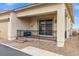 Home's covered patio with wrought iron railing and brick-paved sitting area at 746 Purple Knoll Walk, Henderson, NV 89011