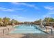 Outdoor pool surrounded by seating areas, umbrellas and desert landscaping with blue skies at 746 Purple Knoll Walk, Henderson, NV 89011