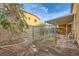 Fenced backyard offering a secure outdoor space with a patio cover and potential for customization at 7568 Shadow Estates Way, Las Vegas, NV 89113