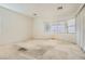Sun-filled bedroom featuring several windows, carpeted flooring, and ample natural light throughout the room at 7568 Shadow Estates Way, Las Vegas, NV 89113