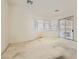 Bright bedroom with sliding glass door, large windows, and carpeted floors offering great natural light at 7568 Shadow Estates Way, Las Vegas, NV 89113