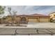 Charming single-story home featuring a three-car garage and well-maintained front yard in a suburban setting at 7568 Shadow Estates Way, Las Vegas, NV 89113
