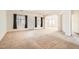 Spacious living room with carpet, large windows, and open layout, ready for personalized design at 7568 Shadow Estates Way, Las Vegas, NV 89113