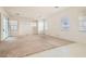 Spacious living room with multiple windows offering great light and sliding glass door to the outside at 7568 Shadow Estates Way, Las Vegas, NV 89113
