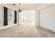 Open living room with chandelier and large windows, a versatile space for relaxation and entertaining at 7568 Shadow Estates Way, Las Vegas, NV 89113