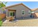 Private backyard with brick-paved patio, low-maintenance gravel, and neutral-toned stucco exterior at 8036 Literature Ct, Las Vegas, NV 89113
