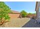 Residential backyard featuring desert landscaping, brick perimeter walls, and a patio set at 8036 Literature Ct, Las Vegas, NV 89113