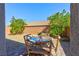 Cozy backyard patio with a rustic wood table set and low-maintenance gravel landscaping at 8036 Literature Ct, Las Vegas, NV 89113