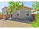 Residential backyard featuring desert landscaping, patio, and building exterior with window views at 8036 Literature Ct, Las Vegas, NV 89113