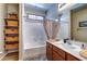 Bathroom featuring a large vanity, a shower/tub combo, and decorative accents at 8036 Literature Ct, Las Vegas, NV 89113