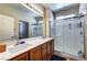 Modern bathroom featuring double sinks, sleek cabinets, and a glass-enclosed shower at 8036 Literature Ct, Las Vegas, NV 89113